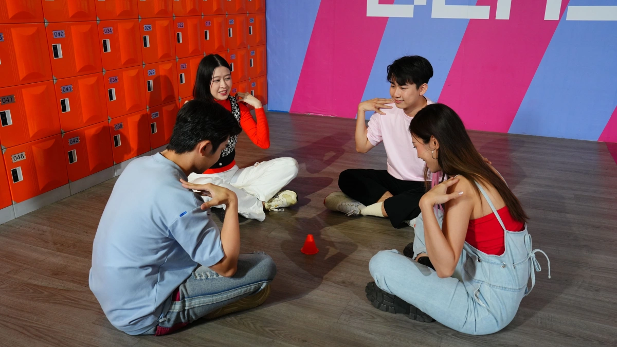 4 adults are having indoor team building games in Malaysia